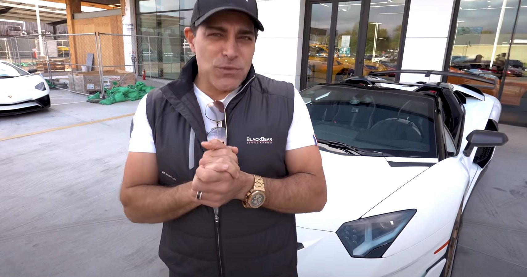 Manny Khoshbin poses with a white Lamborghini Aventador SVJ