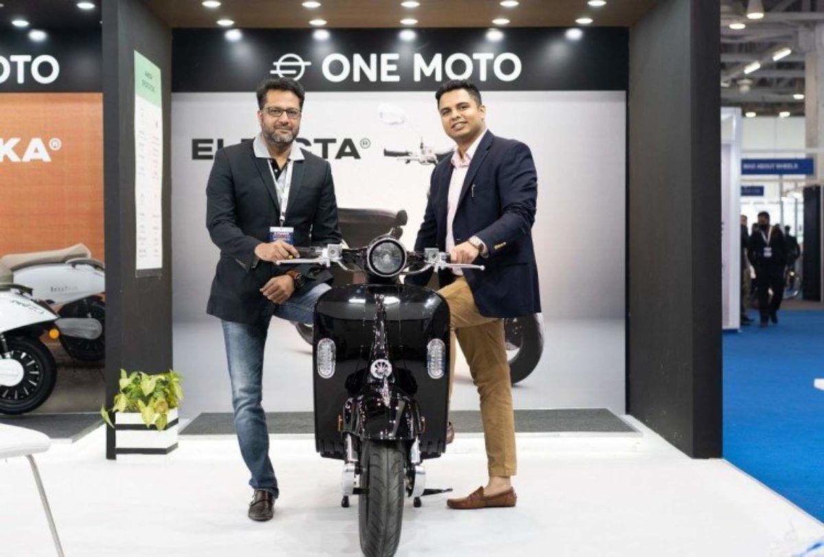 Two people showing off the One Moto Electa