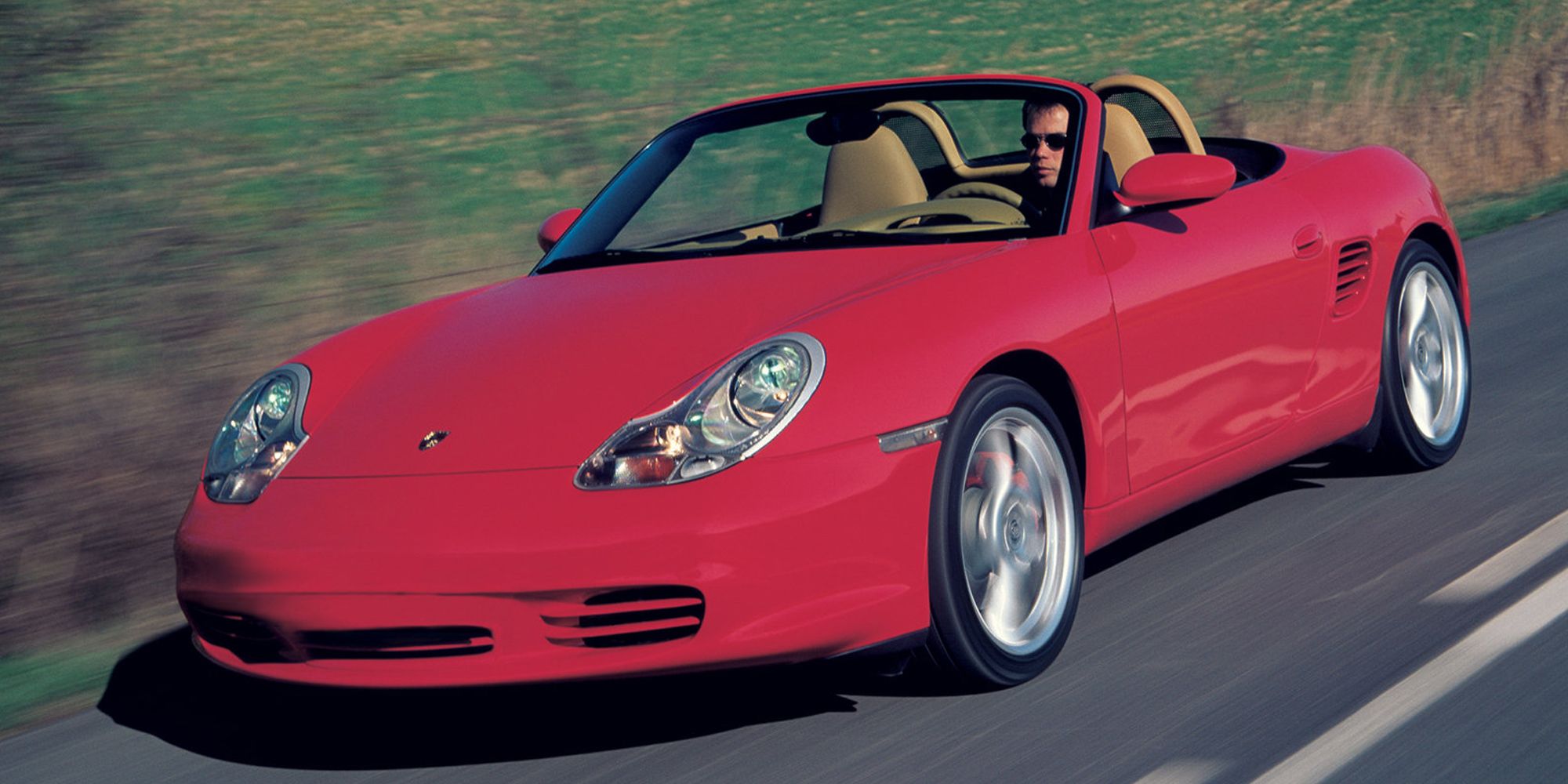 Front 3/4 view of a red Boxster on the move