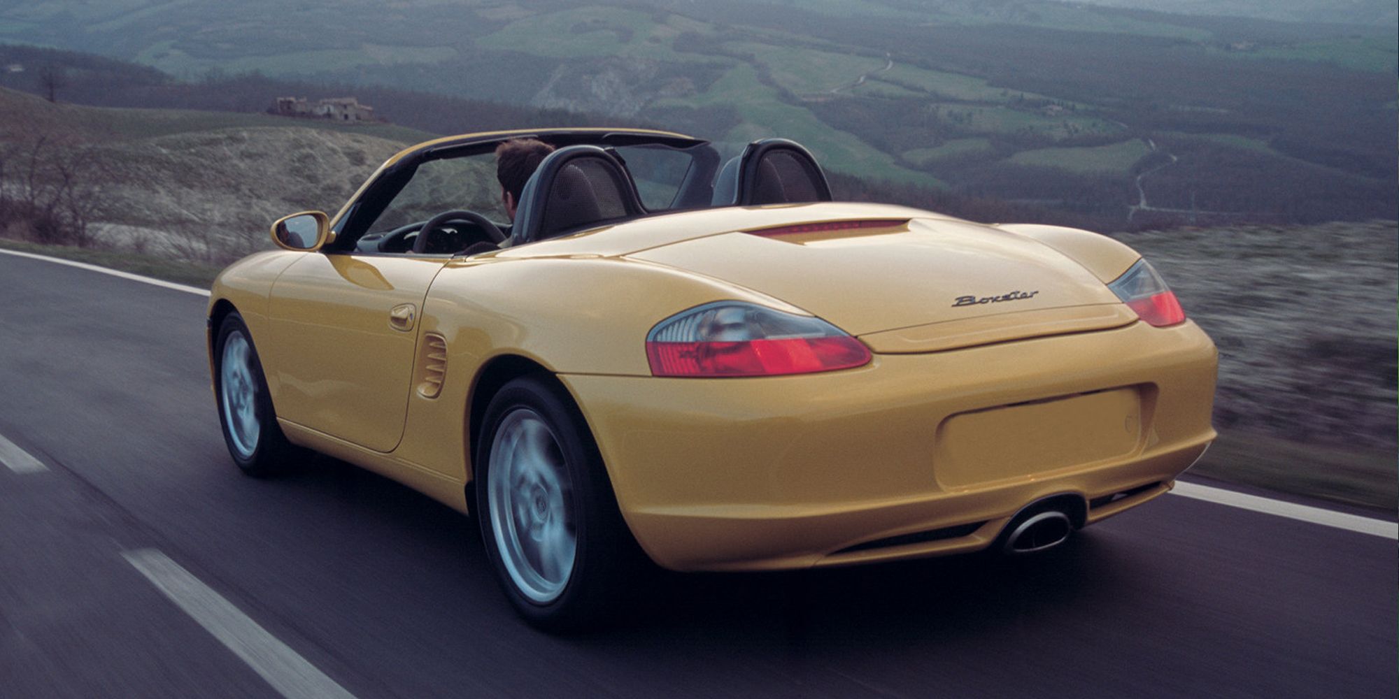 The rear of a yellow Boxster