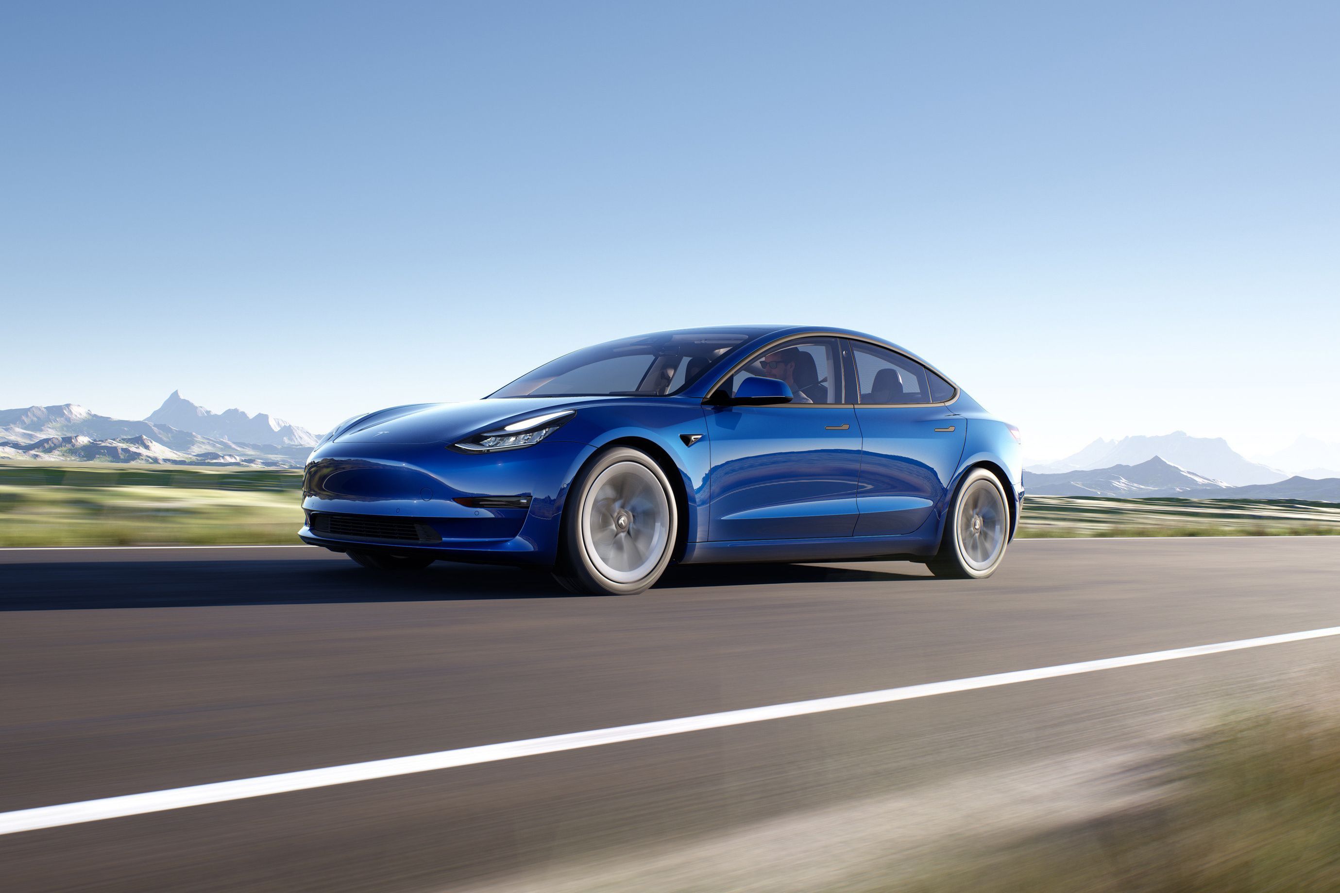Blue Tesla Model 3 on road