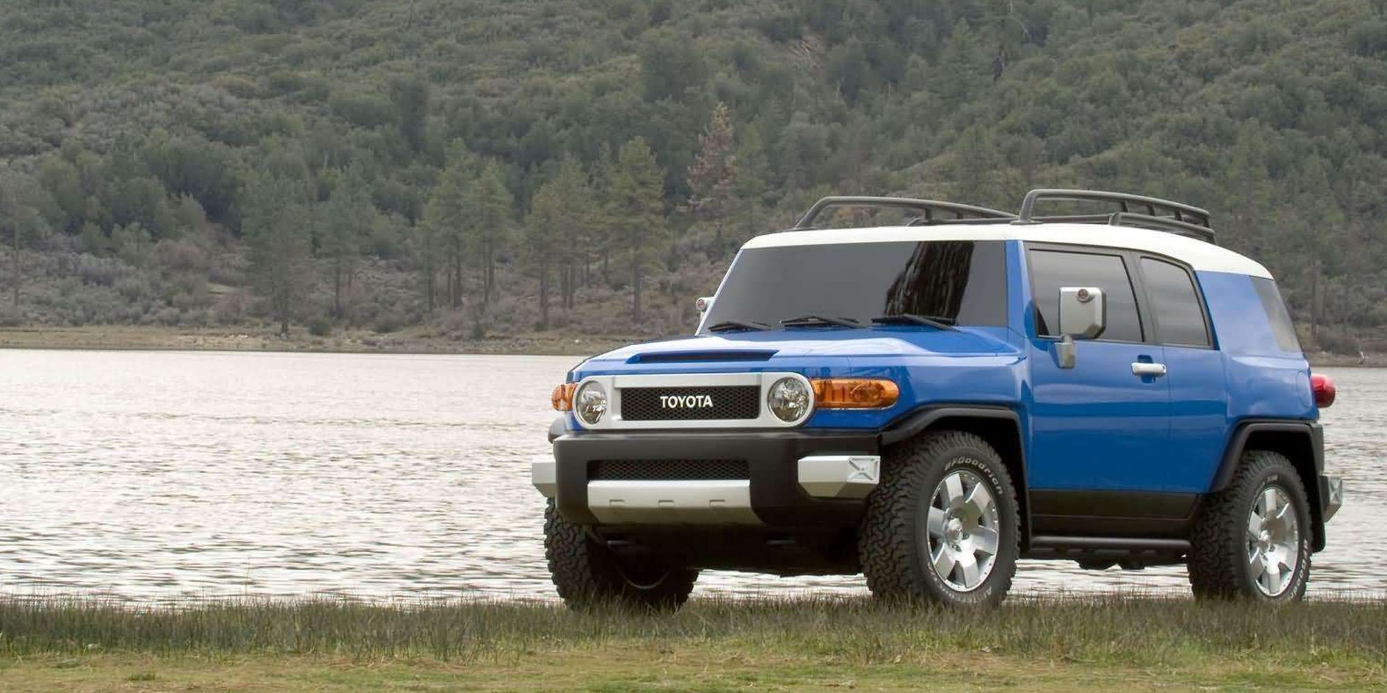 Front 3/4 view of an FJ Cruiser next to a shore, driver's side