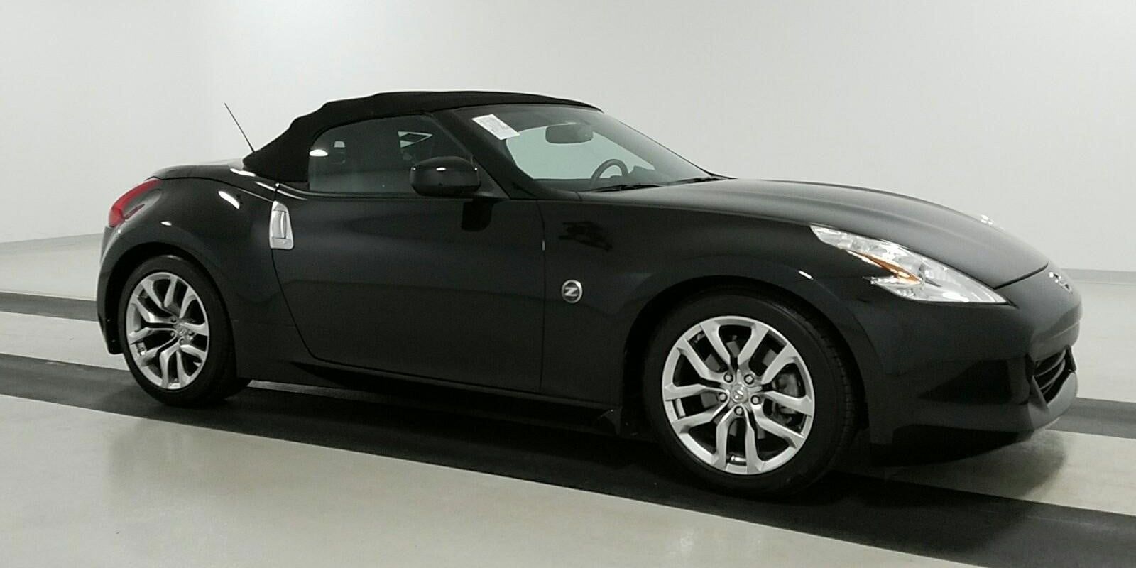 Black 2011 Nissan 370Z Touring Convertible in a garage