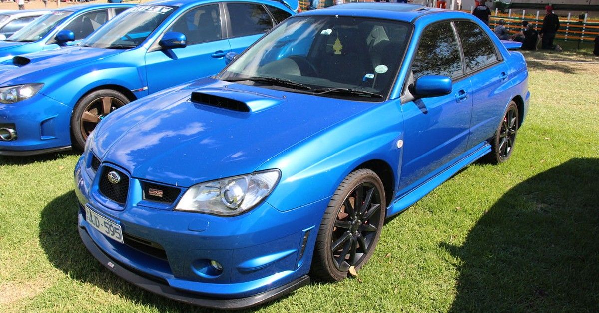 Subaru WRX, blue, front quarter view, on grass at show