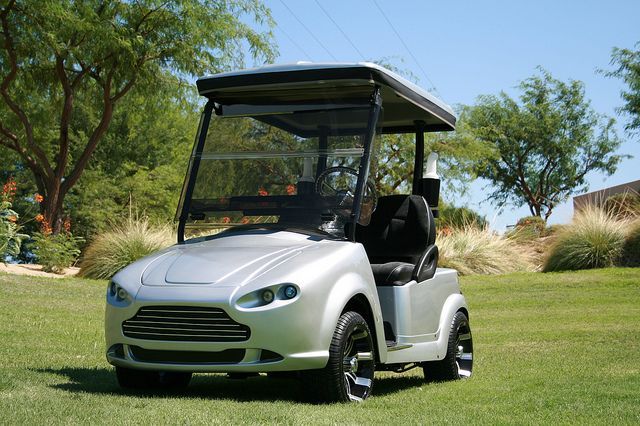 A Customized Aston Martin Golf Cart On The Course