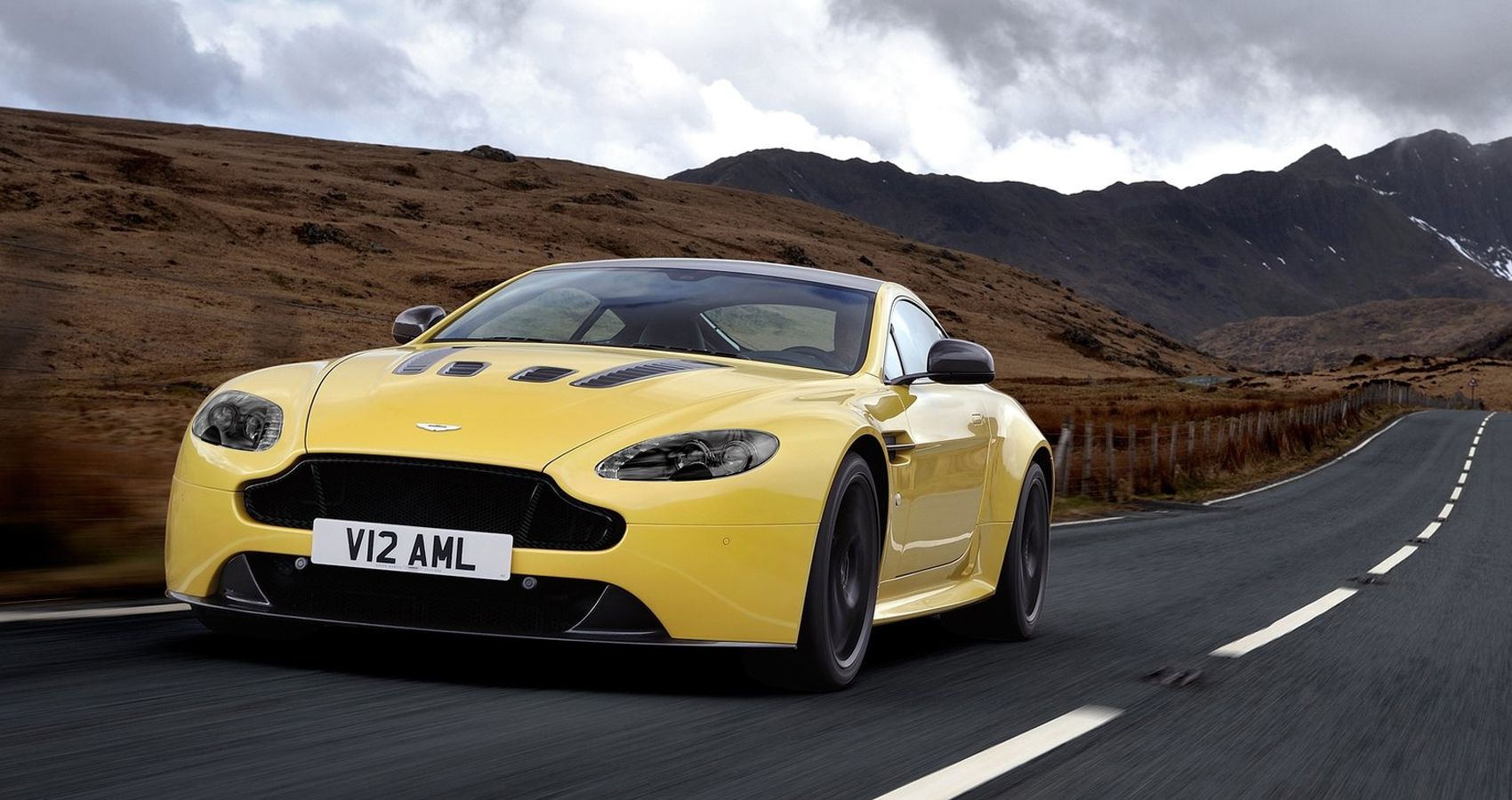 The front of a yellow V12 Vantage S on the move
