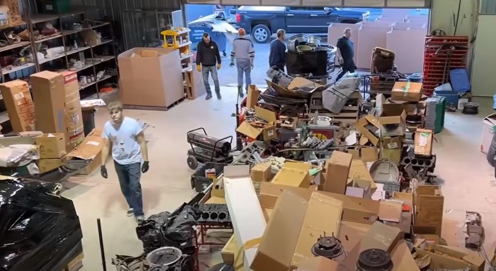Crew loading Camaro parts from warehouse to trucks