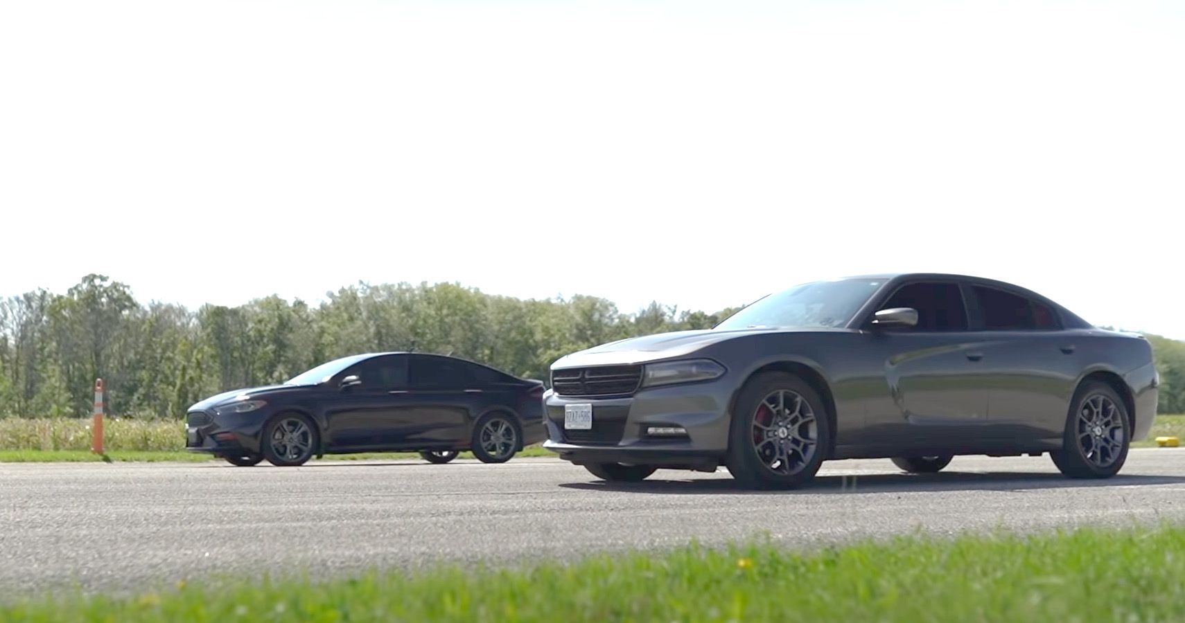 Dodge Charger and Ford Fusion line up on highway
