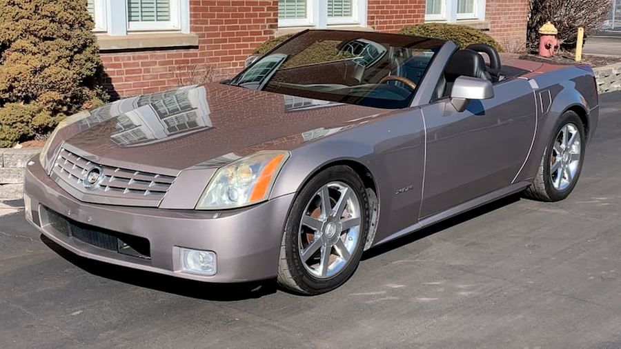 The 2004 Cadillac XLR parked in front of a house.