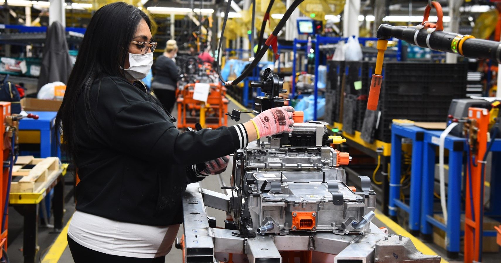 A Ford employee working on the E-Transit battery pack