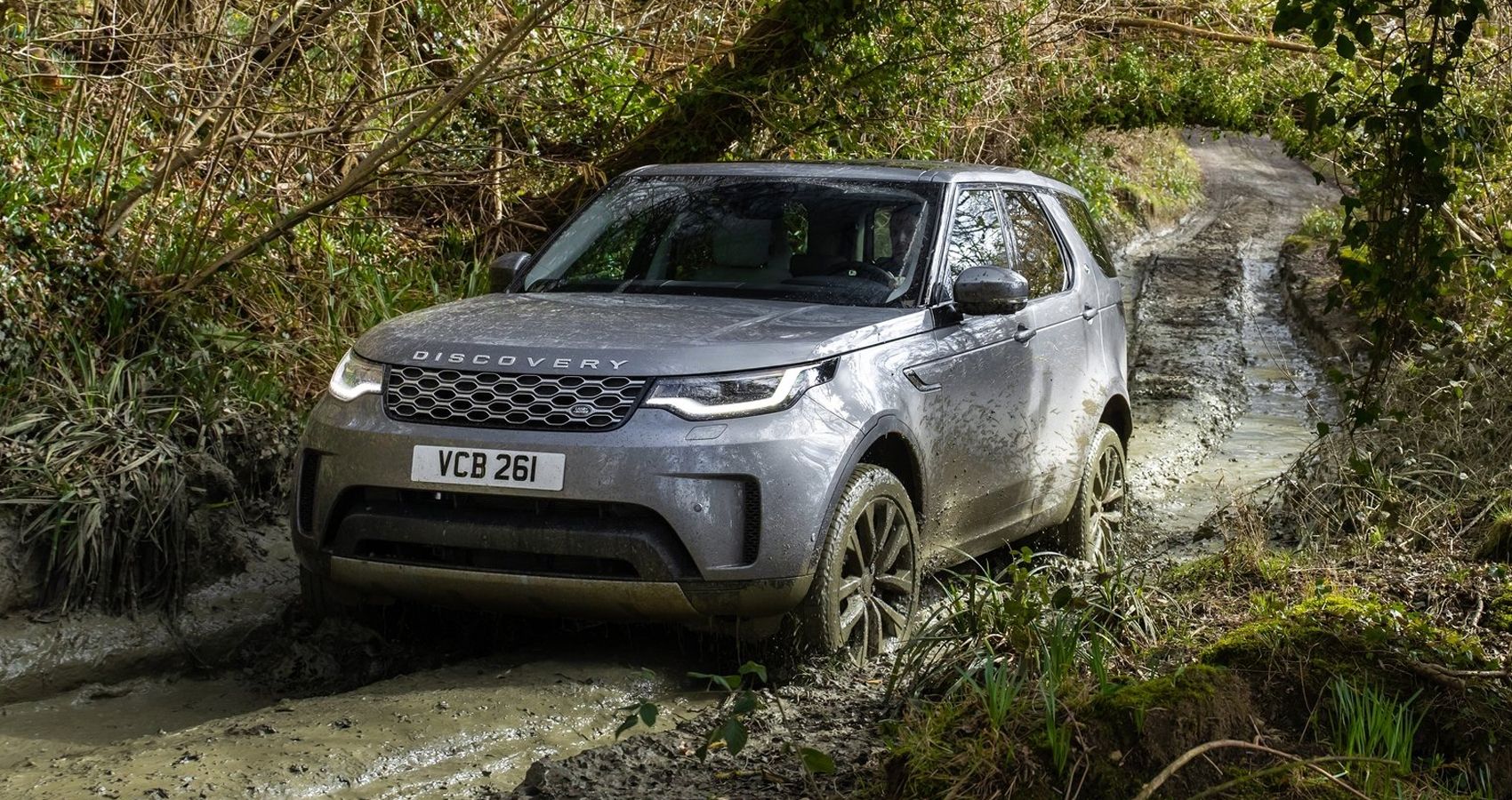 The front of a gray Discovery offroading
