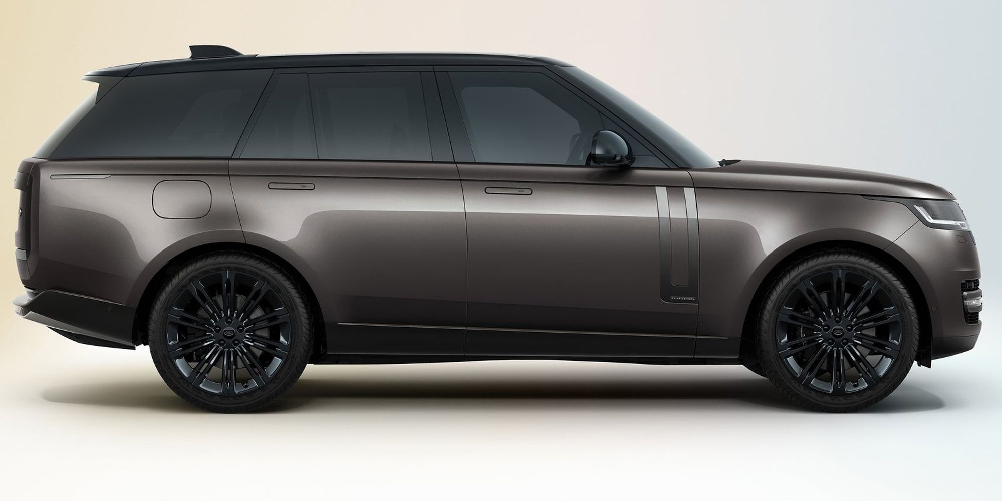 The side of a dark bronze Range Rover, studio render
