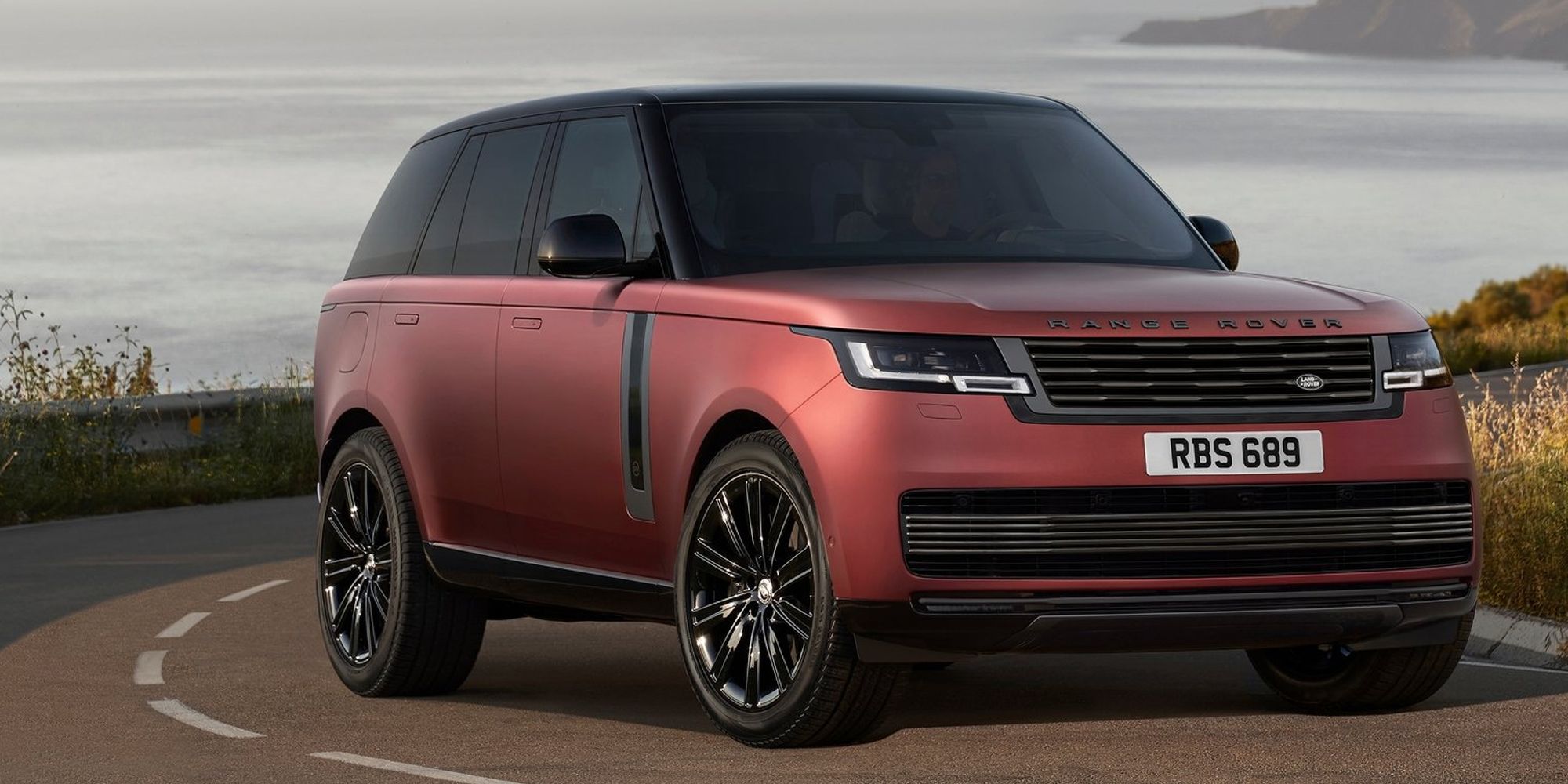 The front of a matte red Range Rover