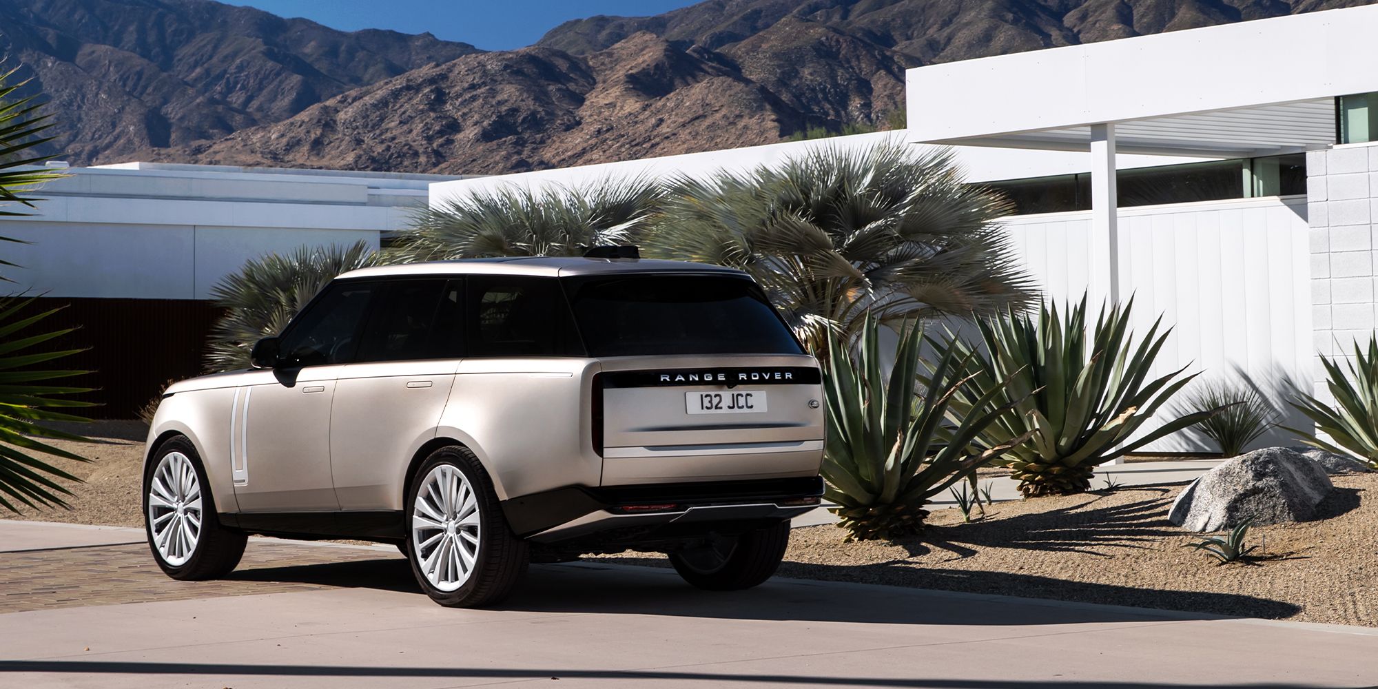 Rear 3/4 view of a silver Range Rover on a driveway