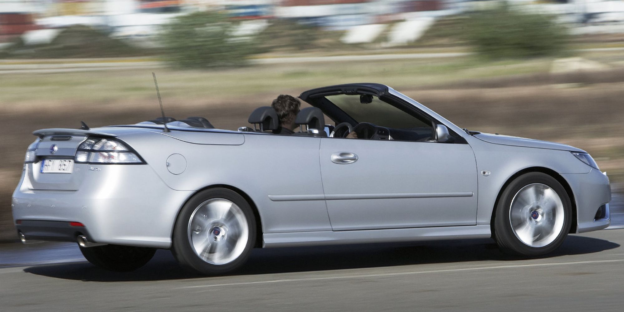 The side of a silver 9-3 Convertible on the move