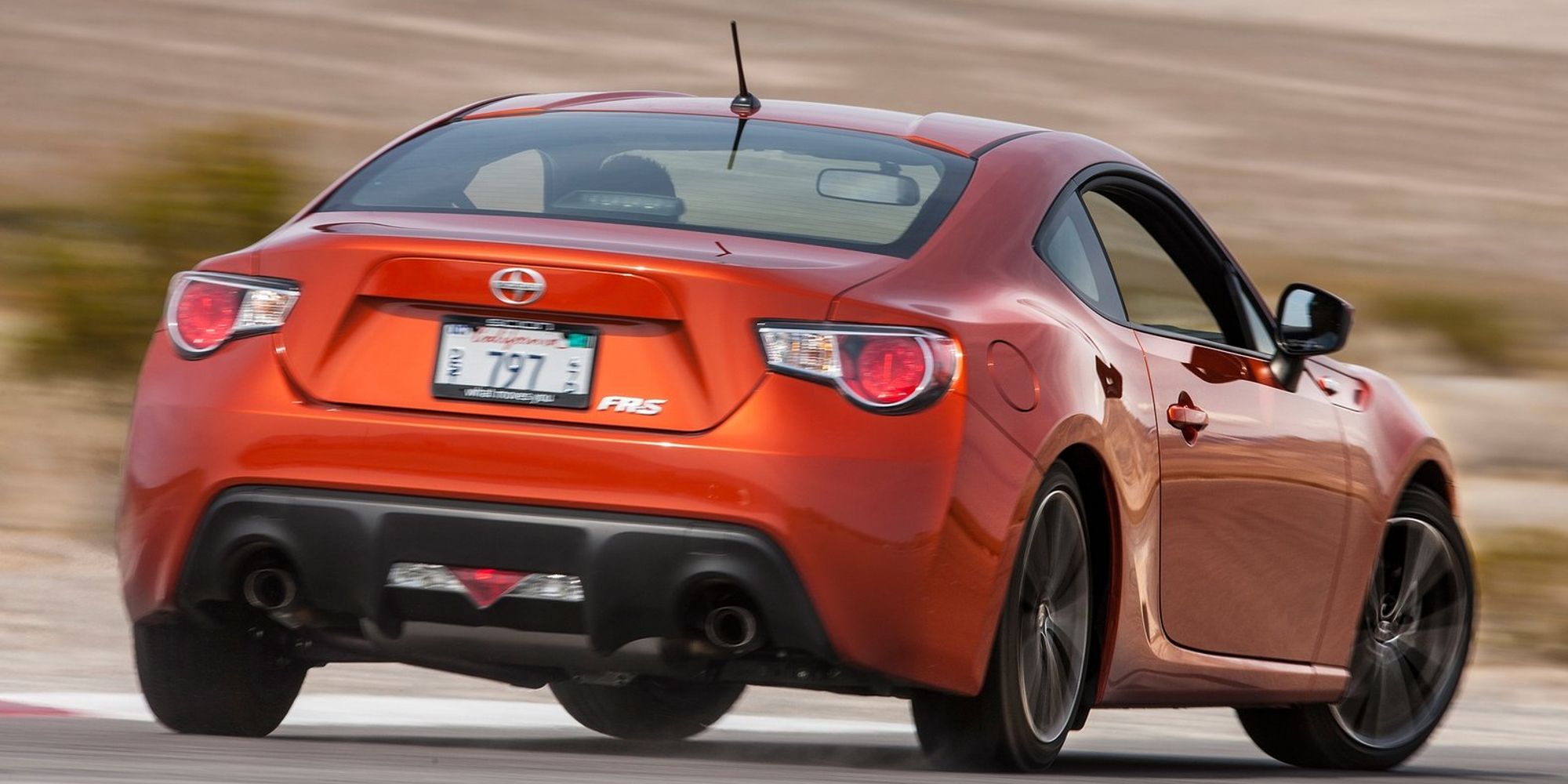 The rear of a red FR-S getting the tail out