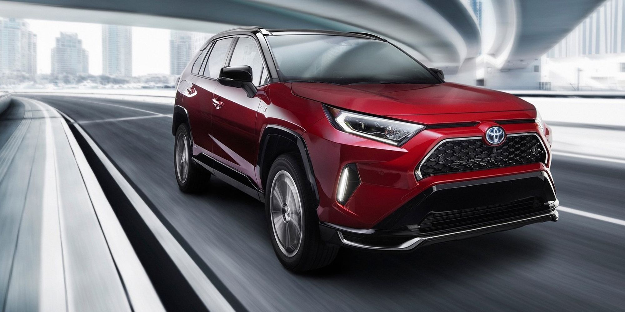 The front of a red RAV4 Prime on the move
