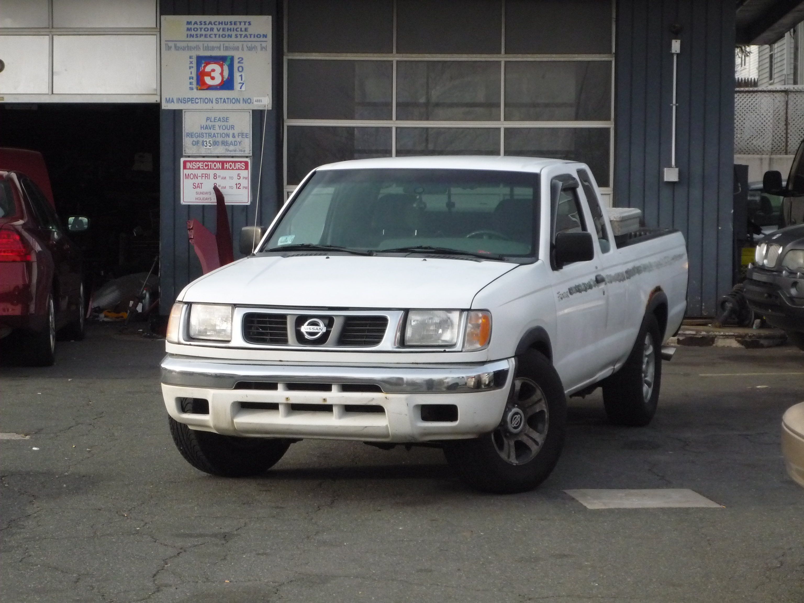 The very first Nissan Navara in front of a mechanic shop.
