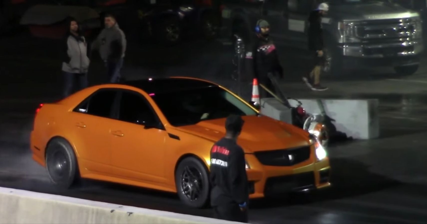 Orange Cadillac CTS-V at the start of the drag race - nickname is Rocket
