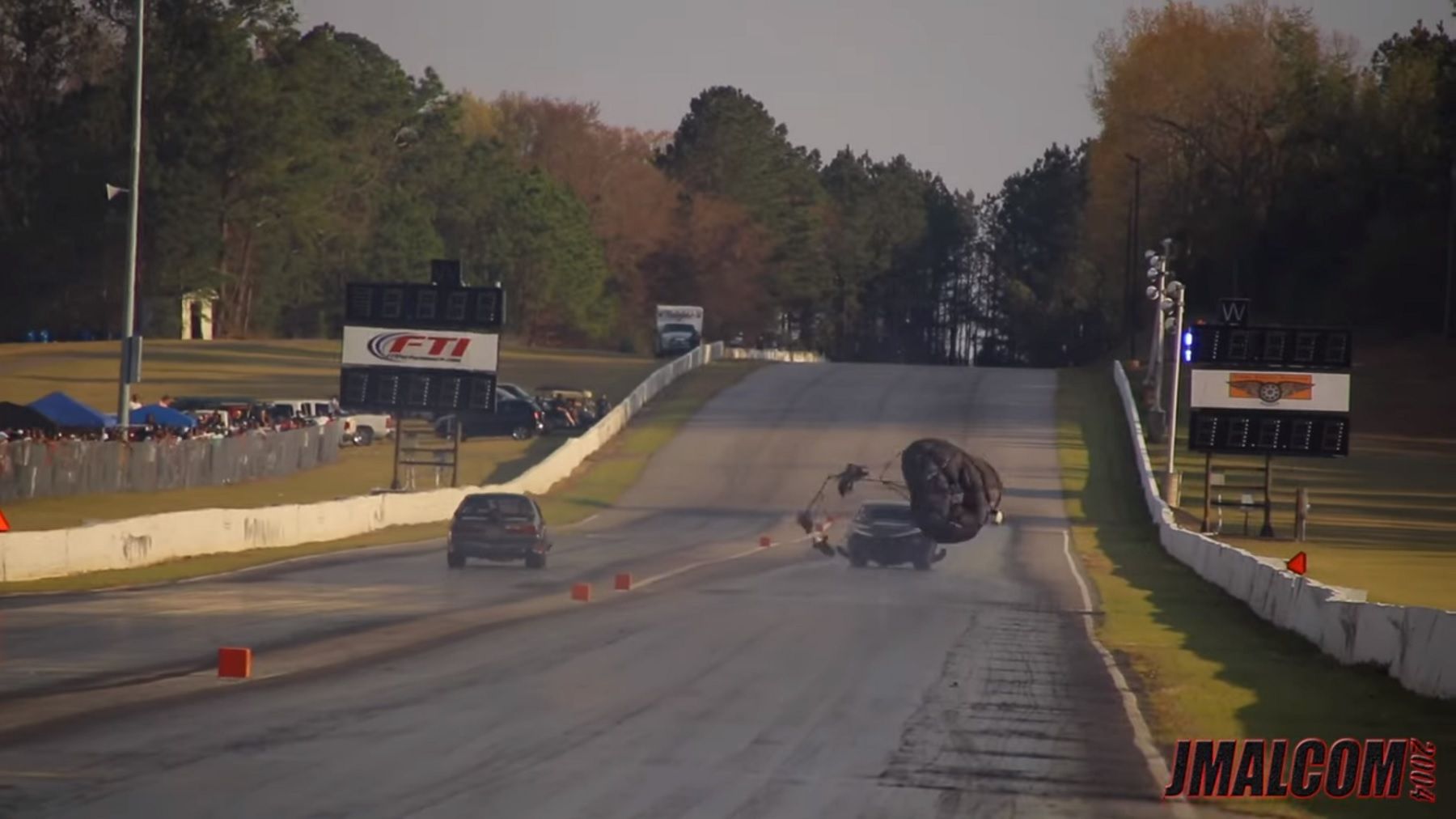 Chevrolet Malibu Drag Racer, rear from distance, parachute falls off