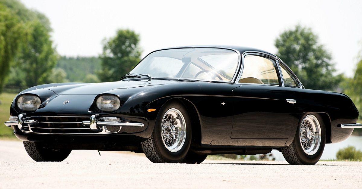 Black Lamborghini 350 GT in front of trees