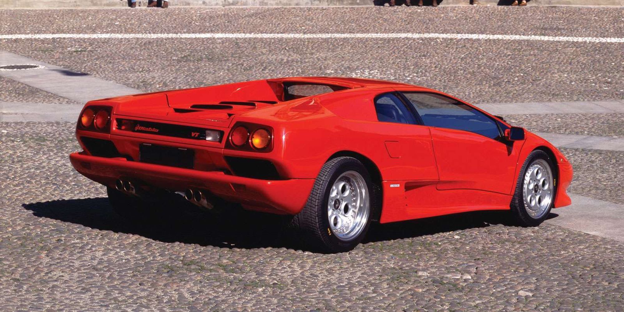 Rear 3/4 view of a red Diablo on a square