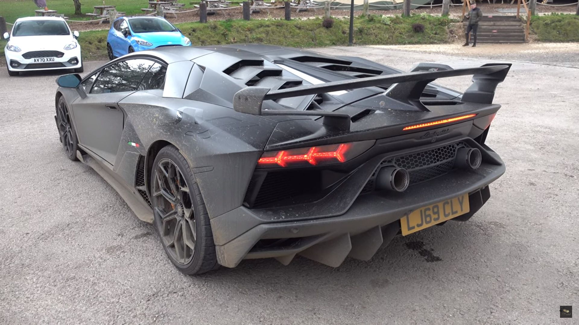 Lamborghini SVJ, black, rear quarter view, parked in lot