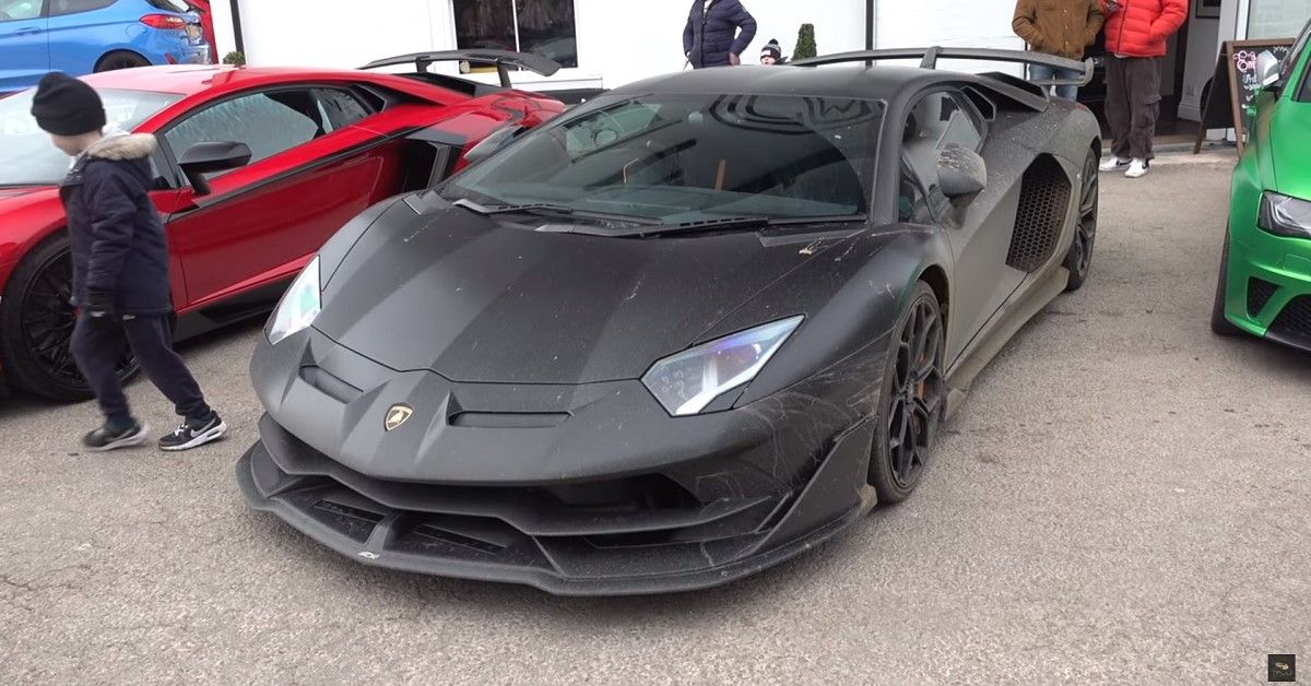 Lamborghini SVJ, black, front quarter view, parked at car meet