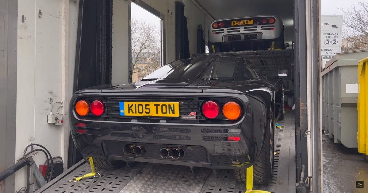 McLaren F1s inside transport truck, one up one down, rear view