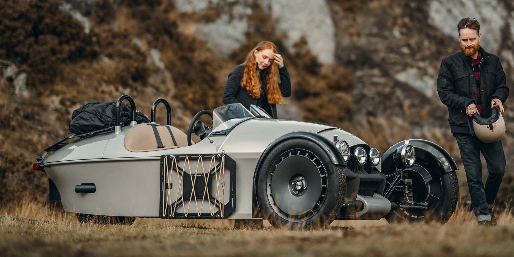 Front 3/4 view of a gray Morgan Super 3 near a cliffside