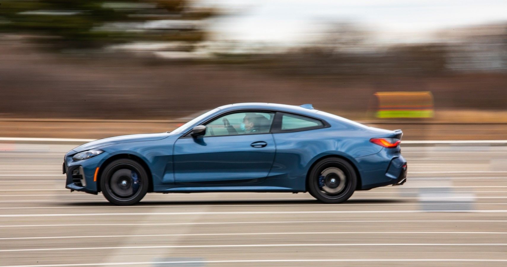 BMW M4 accelerating side view