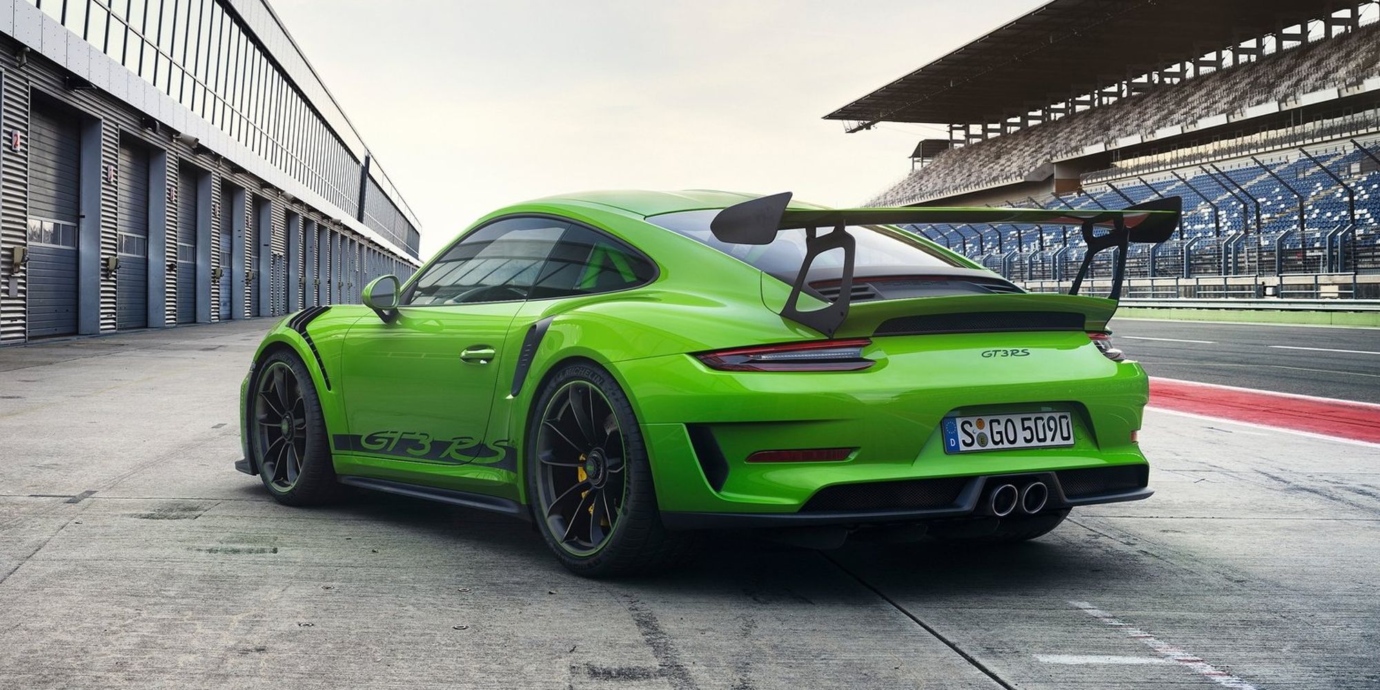 Rear 3/4 view of a green 911 GT3 RS in the pit lane
