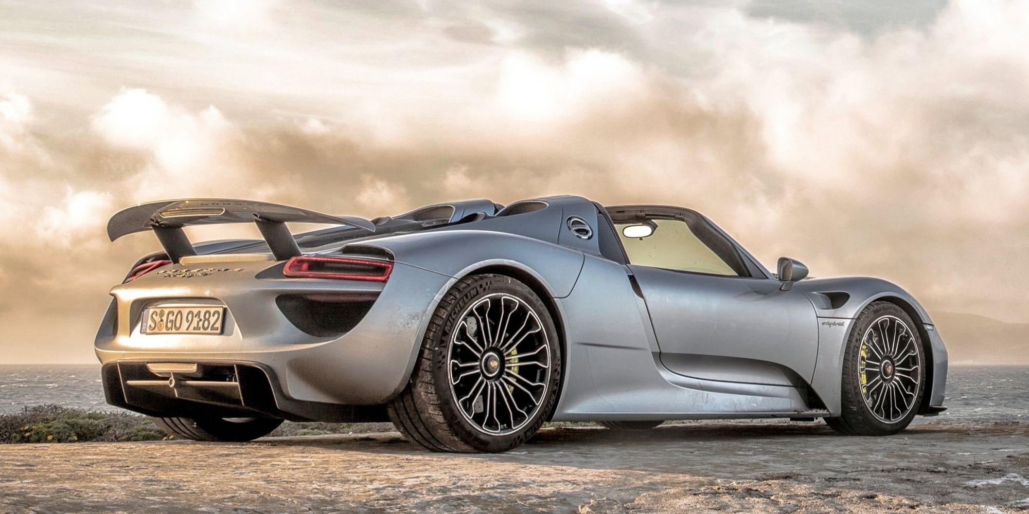 Rear 3/4 view of a silver 918 Spyder