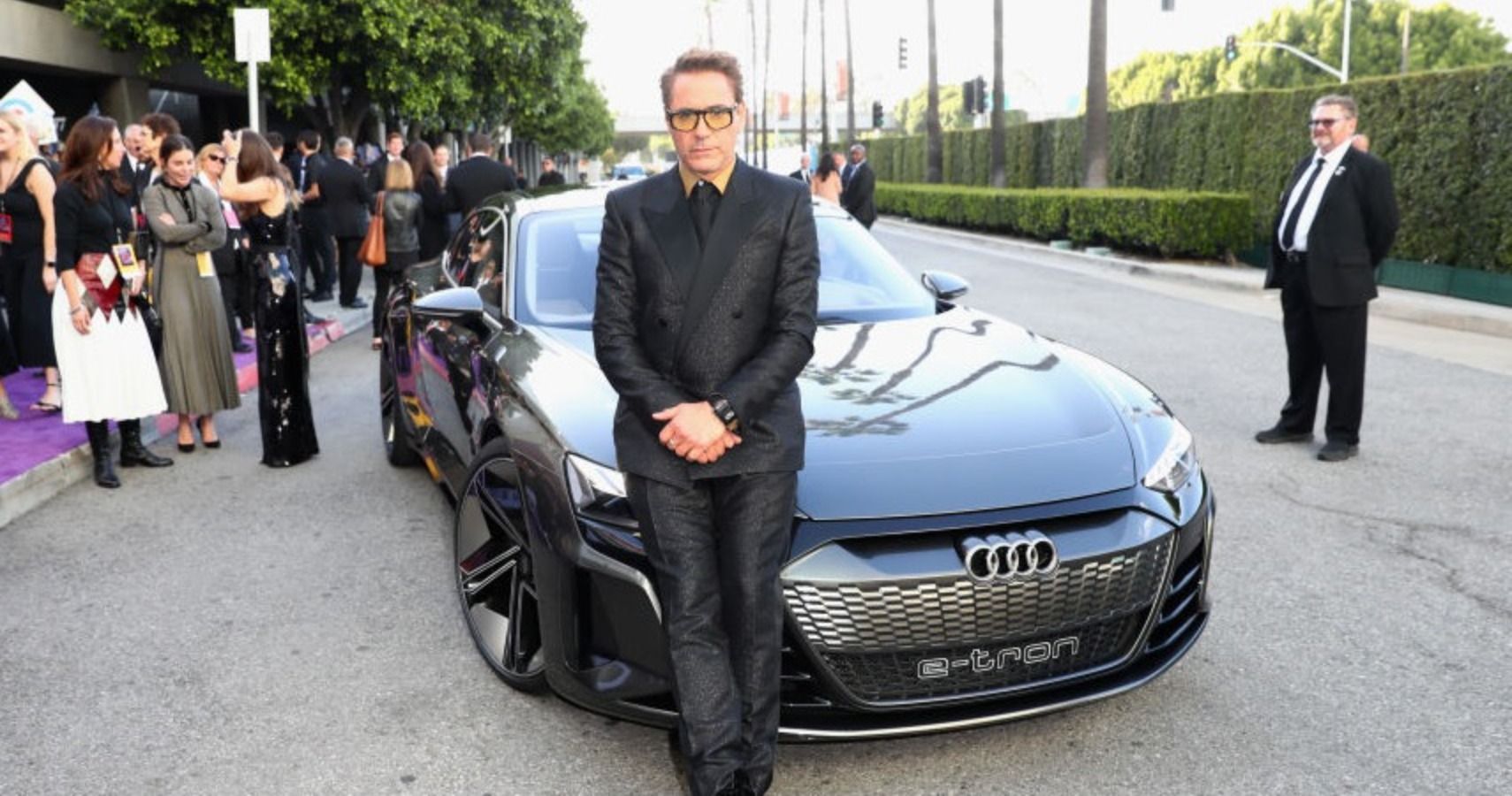Robert Downey Jr. standing next to his Audi e-tron GT