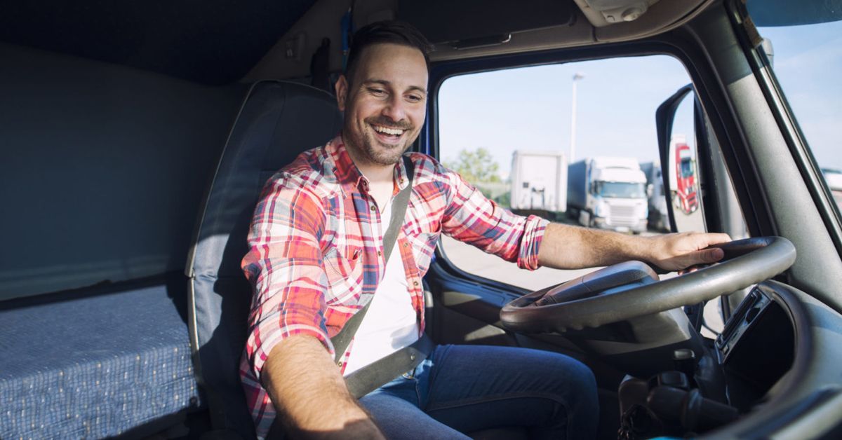 Semi truck driver listening to music in the cab