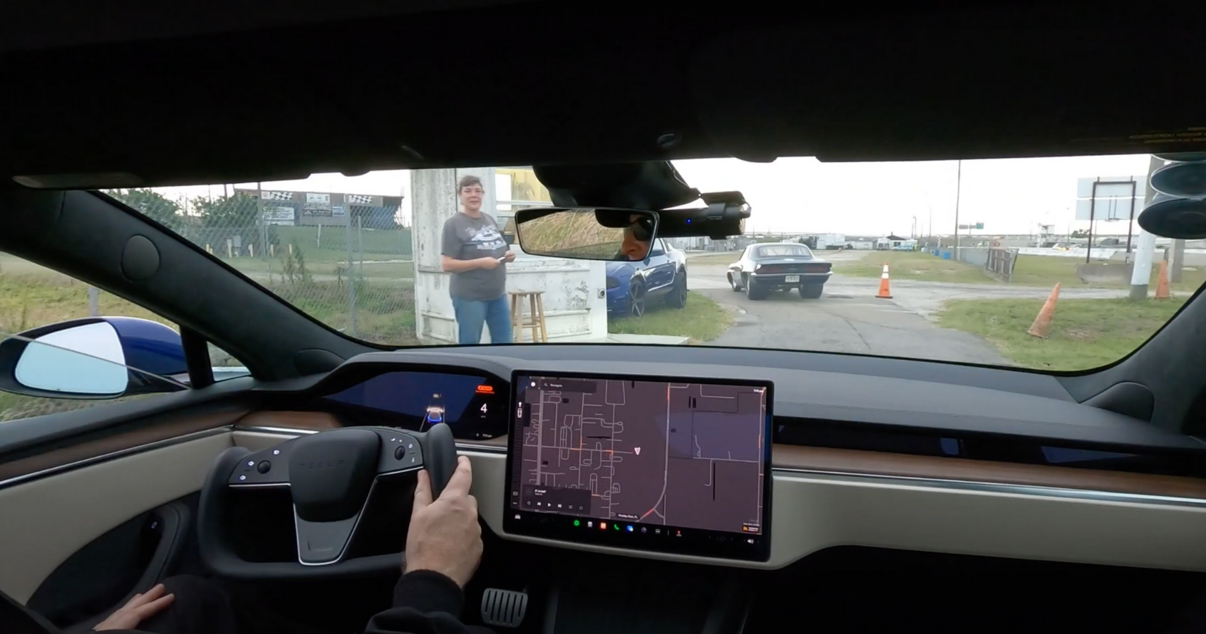 A driver's eye view of the dashboard of a Tesla Plaid