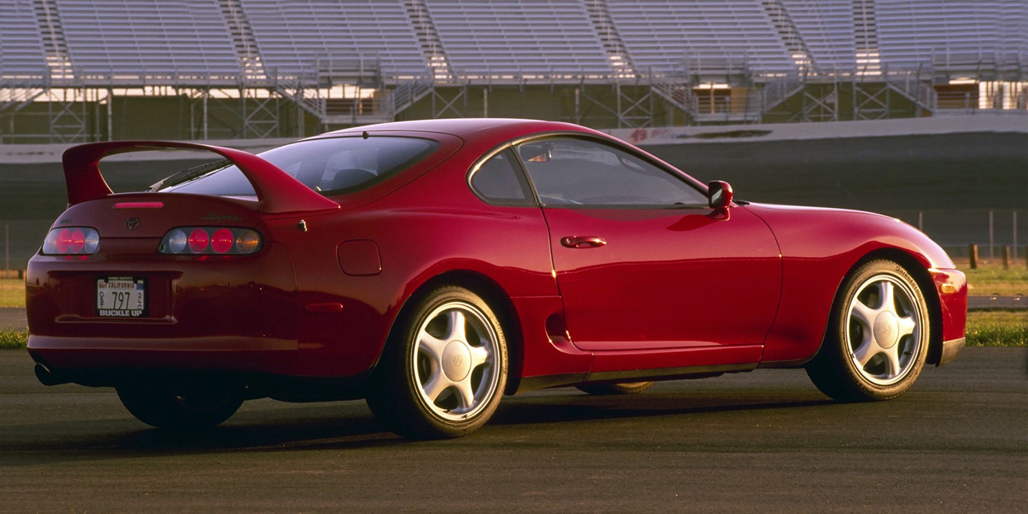 Rear 3/4 view of a red Supra Mk4 