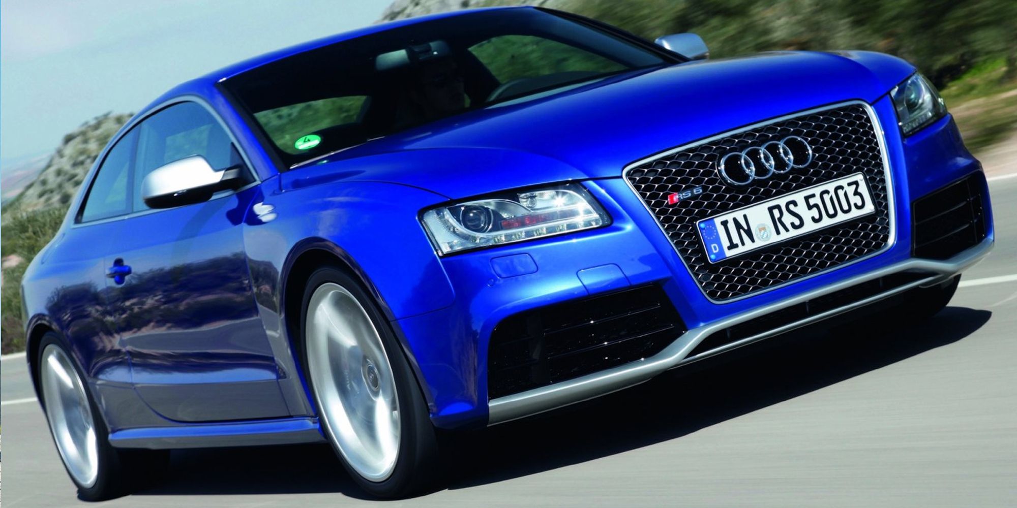 The front of a blue first generation RS5 on the move