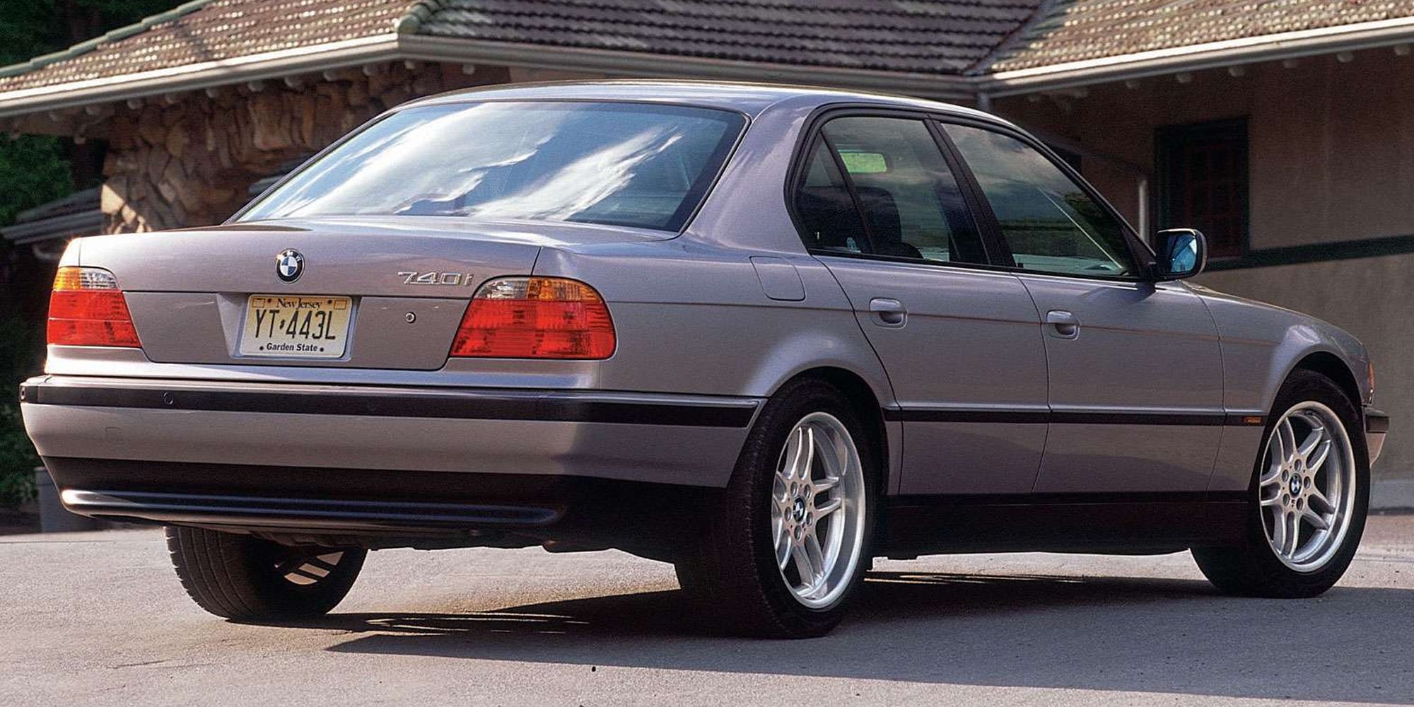 Rear 3/4 view of a grayish silver E38 740i