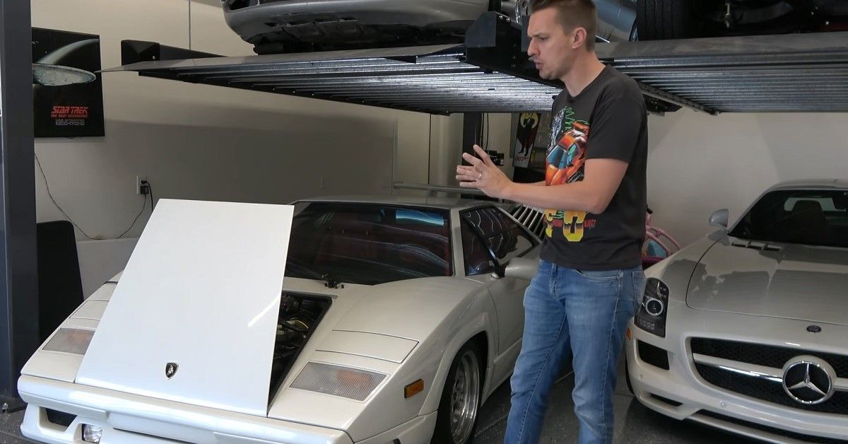 Lamborghini Countach in garage, white, hood up, presenter at side