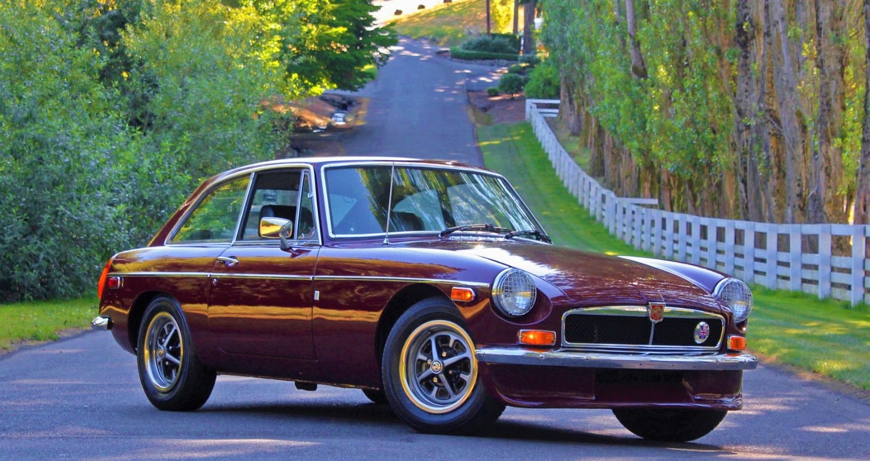 Maroon MGB GT coupe parked
