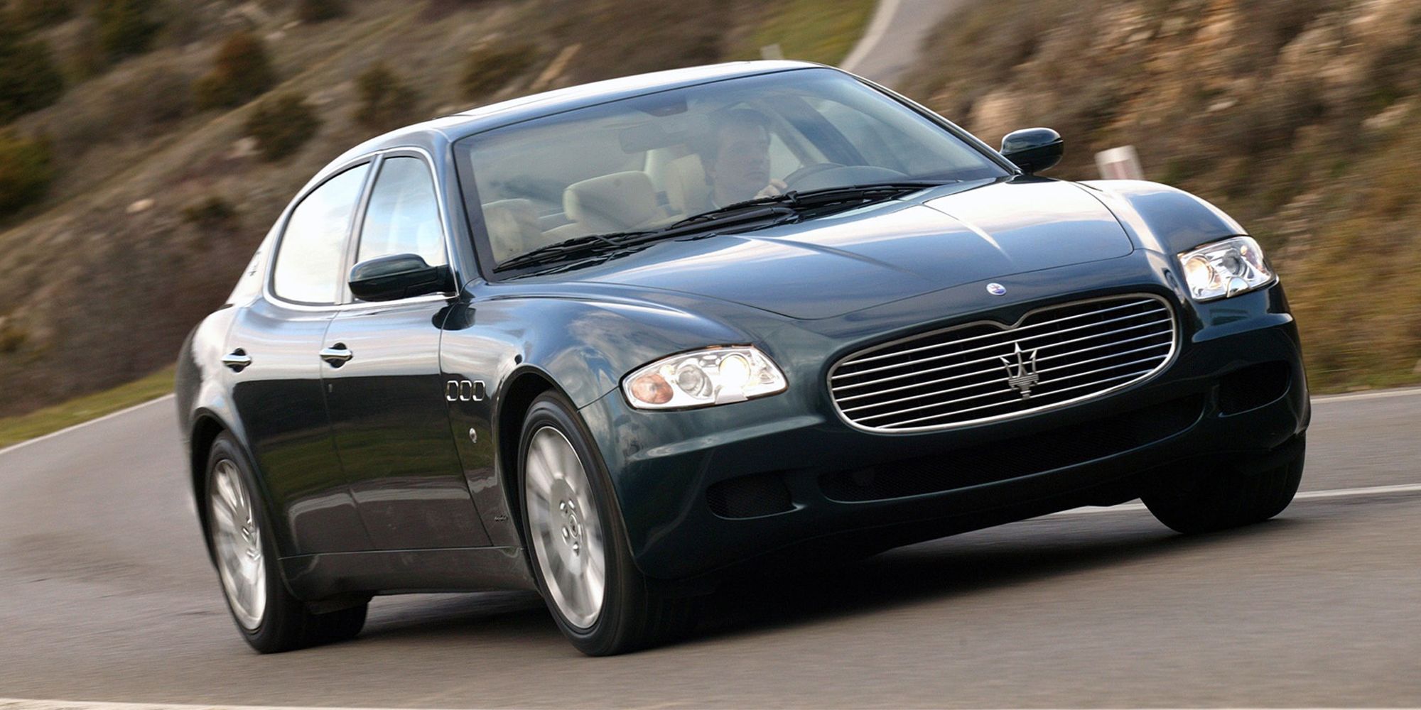 The front of a dark green Quattroporte on the move