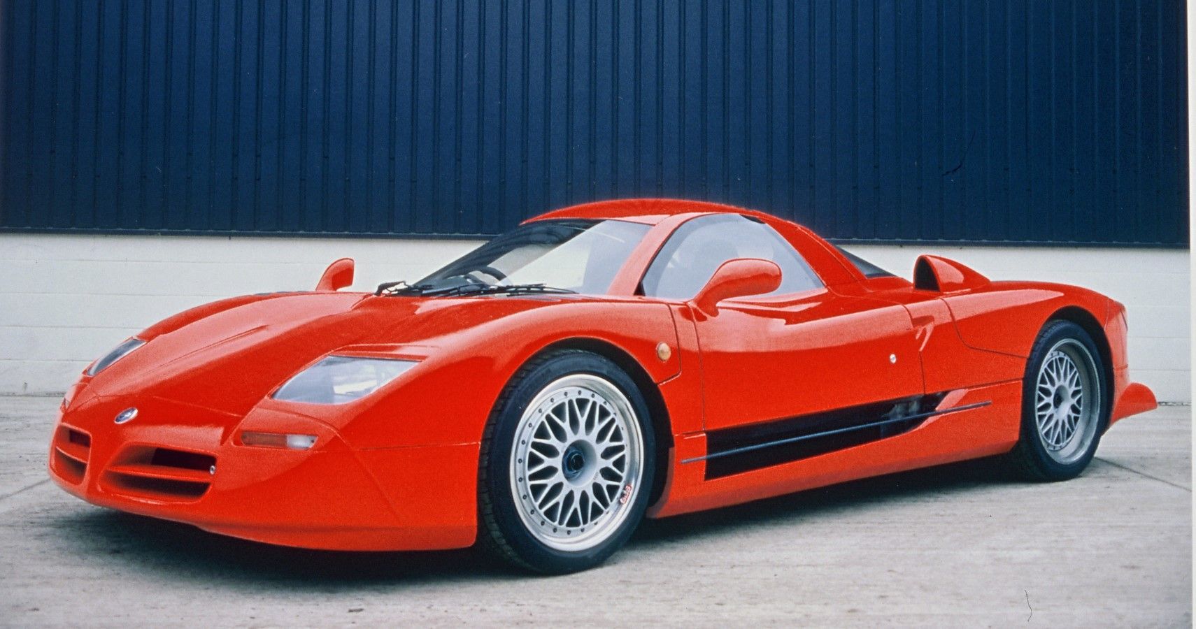 Nissan R390 GT1 in red front third quarter view