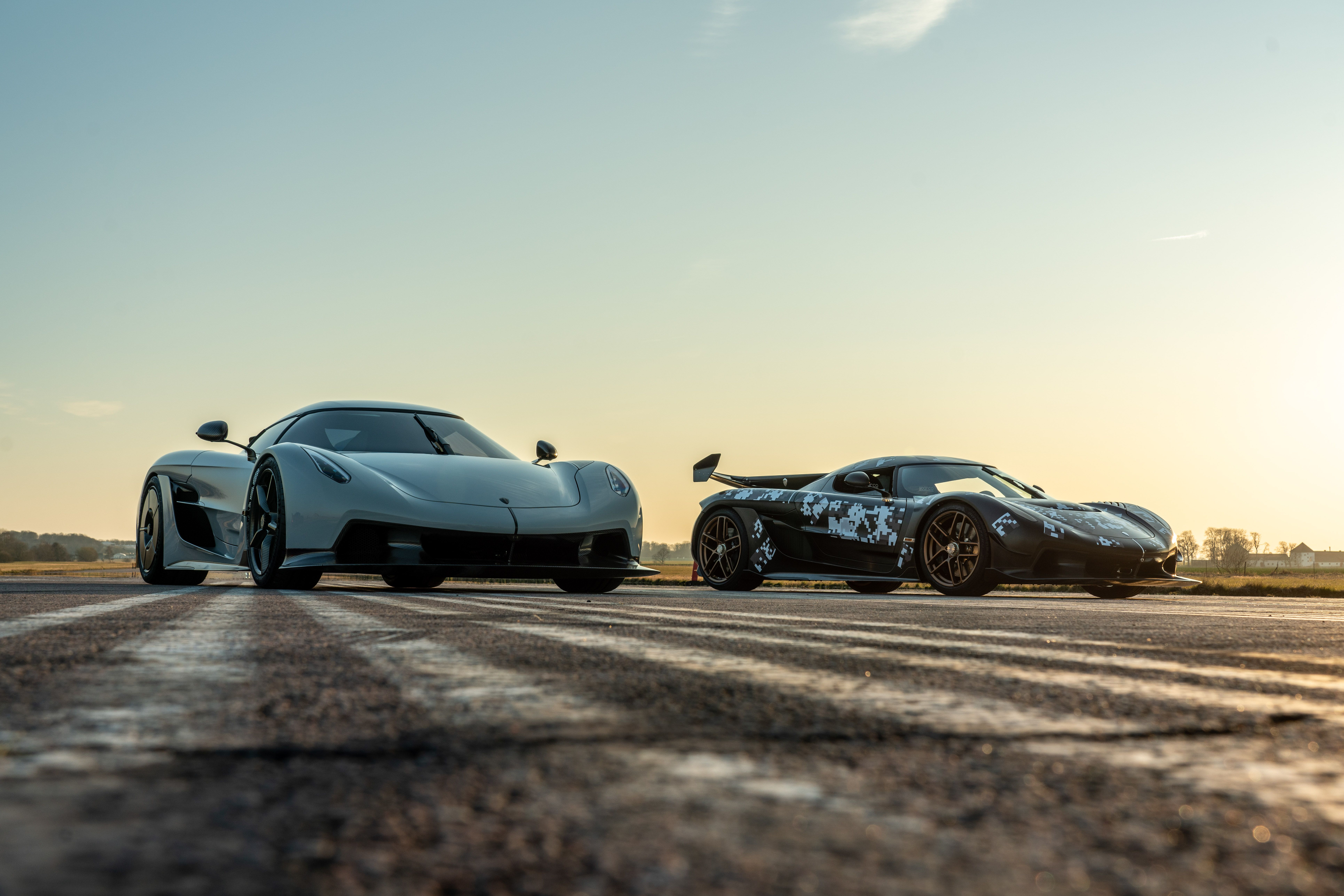 Two Koenigsegg Jesko Absolut models parked on a track.