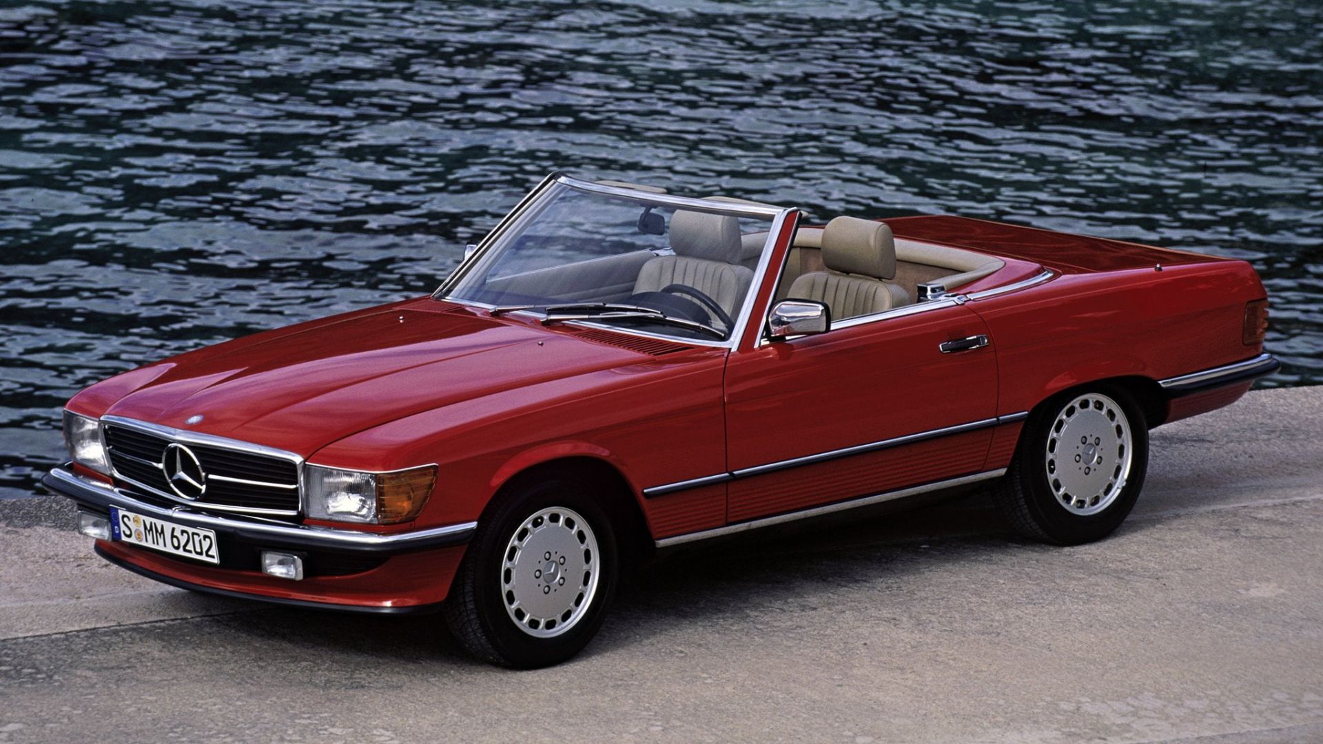 Red R107 SL convertible parked