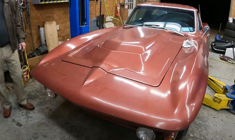 1965 Chevrolet Corvette, burnt red, front quarter close up in garage on lift
