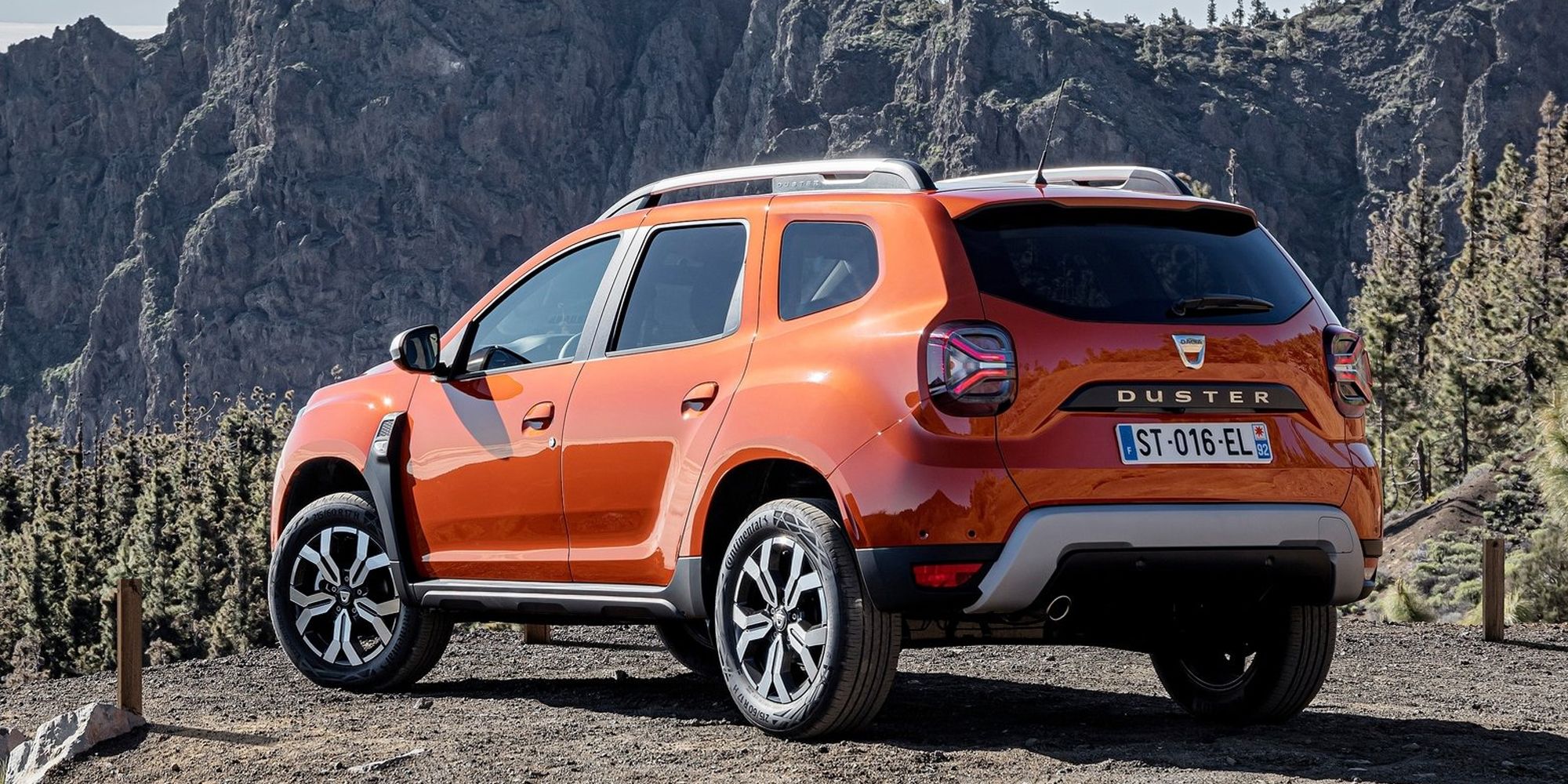 Rear 3/4 view of the Duster in orange