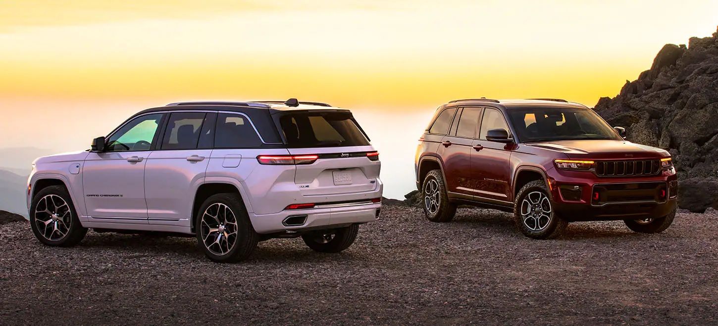 2022 Jeep Grand Cherokee with second car, white and then red, desert, front quarter and then rear quarter