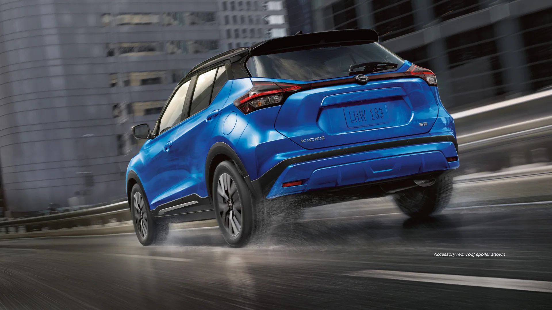 Blue 2023 Nissan Kicks on the road