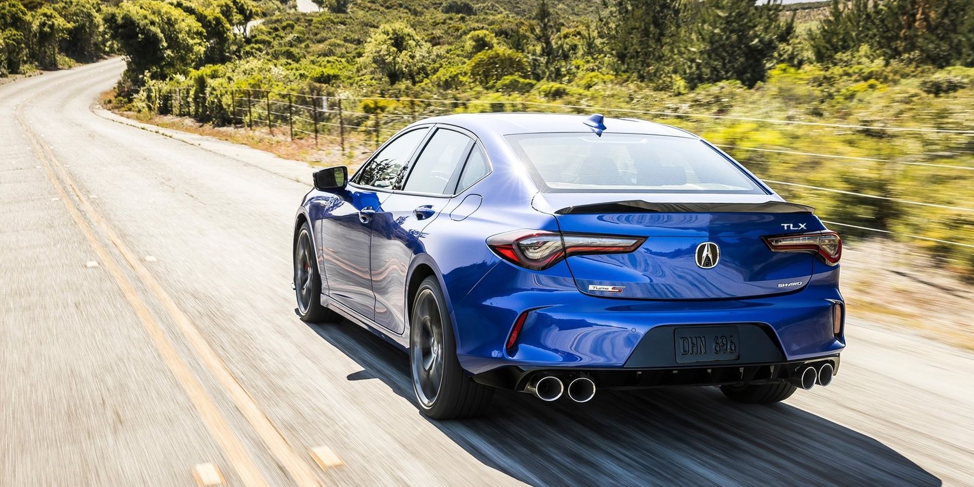 The rear of a blue TLX Type-S on the move